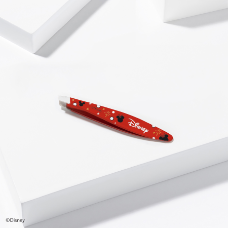 Disney's Mickey Mouse &amp; Minnie Mouse Magic All Around Mini Slant Tweezer placed on a white block tray