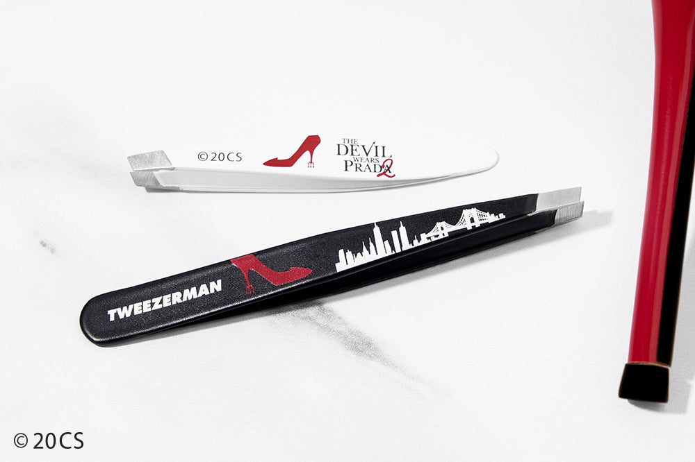 White Mini Slant and Black full slant Tweezer with 'The Devil Wears Prada' branding on a white background