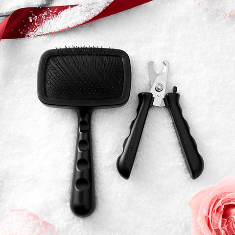 TWEEZERMAN PET SLICKER BRUSH FOR LARGE PERTS IN BLACK, NAIL PRECISION CLIPPER WITH BLACK HANDLES AND STAINLESS STEEL BLACKS.