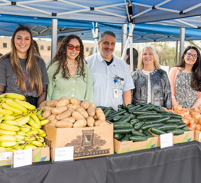Tweezerman Team Members Portrait at  a Fresh Vegetables Market community event. 