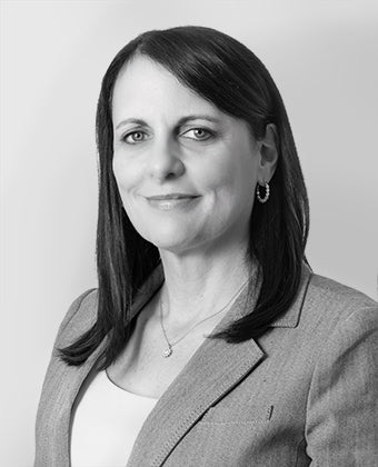 Black and white portrait of a woman with a neutral background