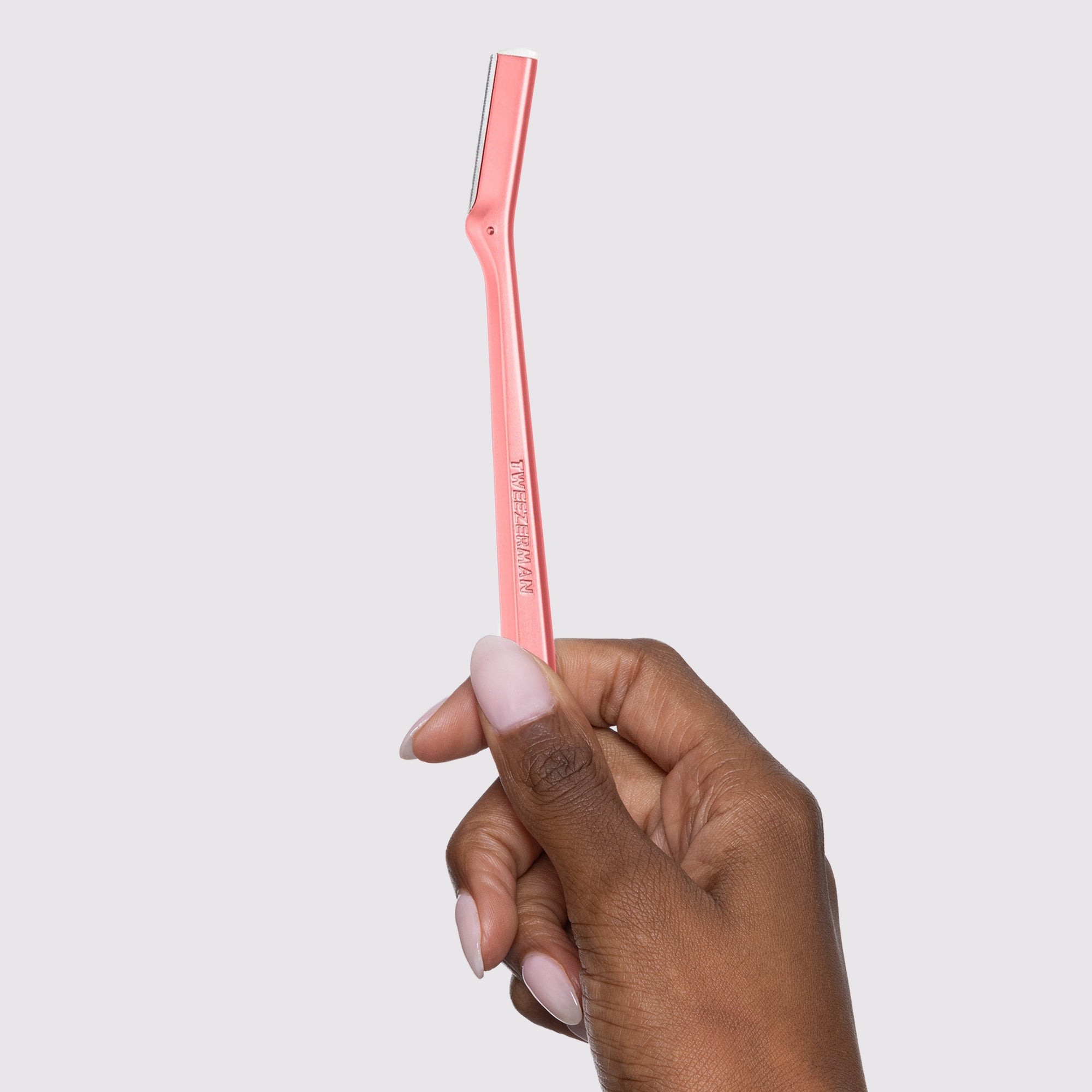 Model holding Tea Rose Metal Facial Razor