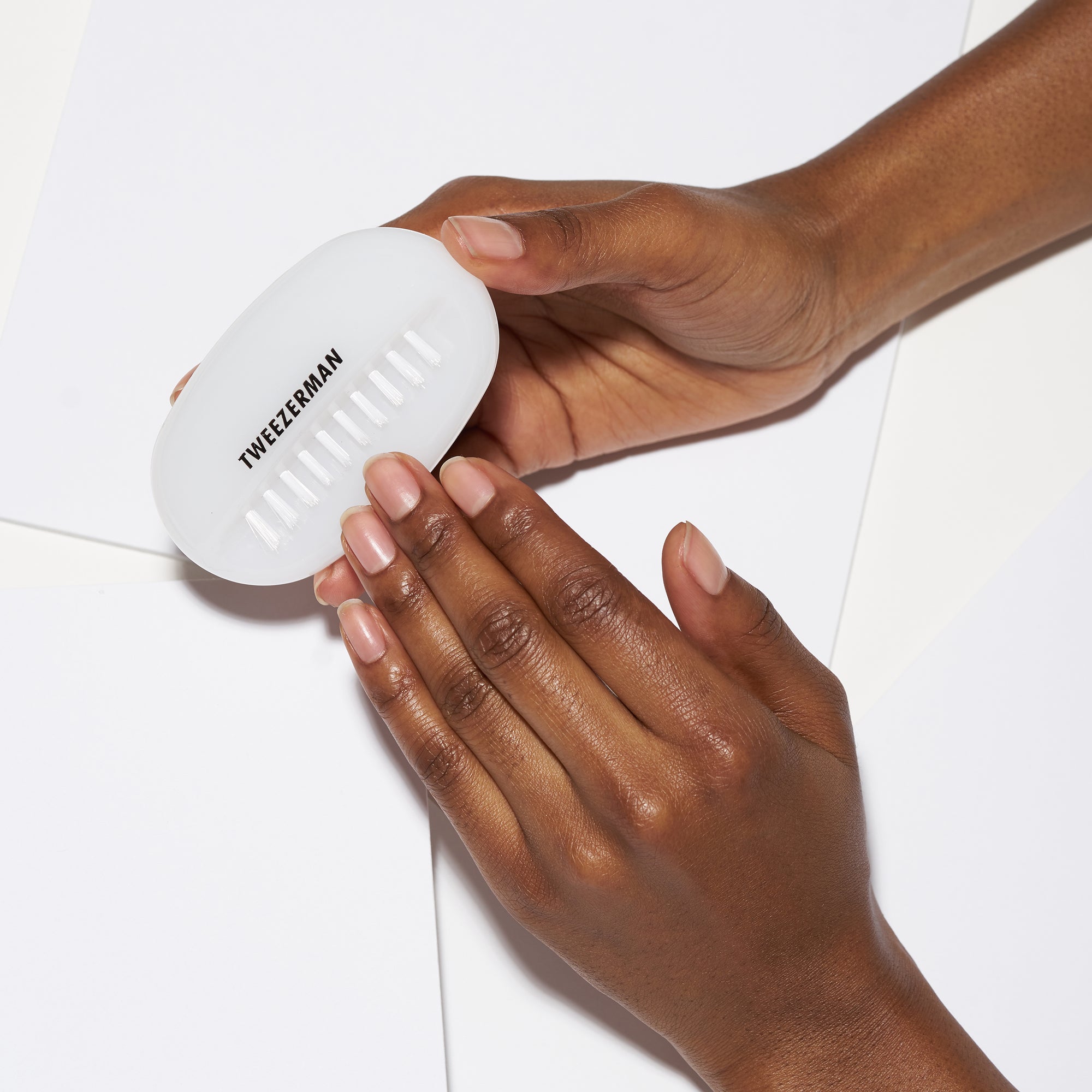 Model using bristles on bottom of dual nail brush