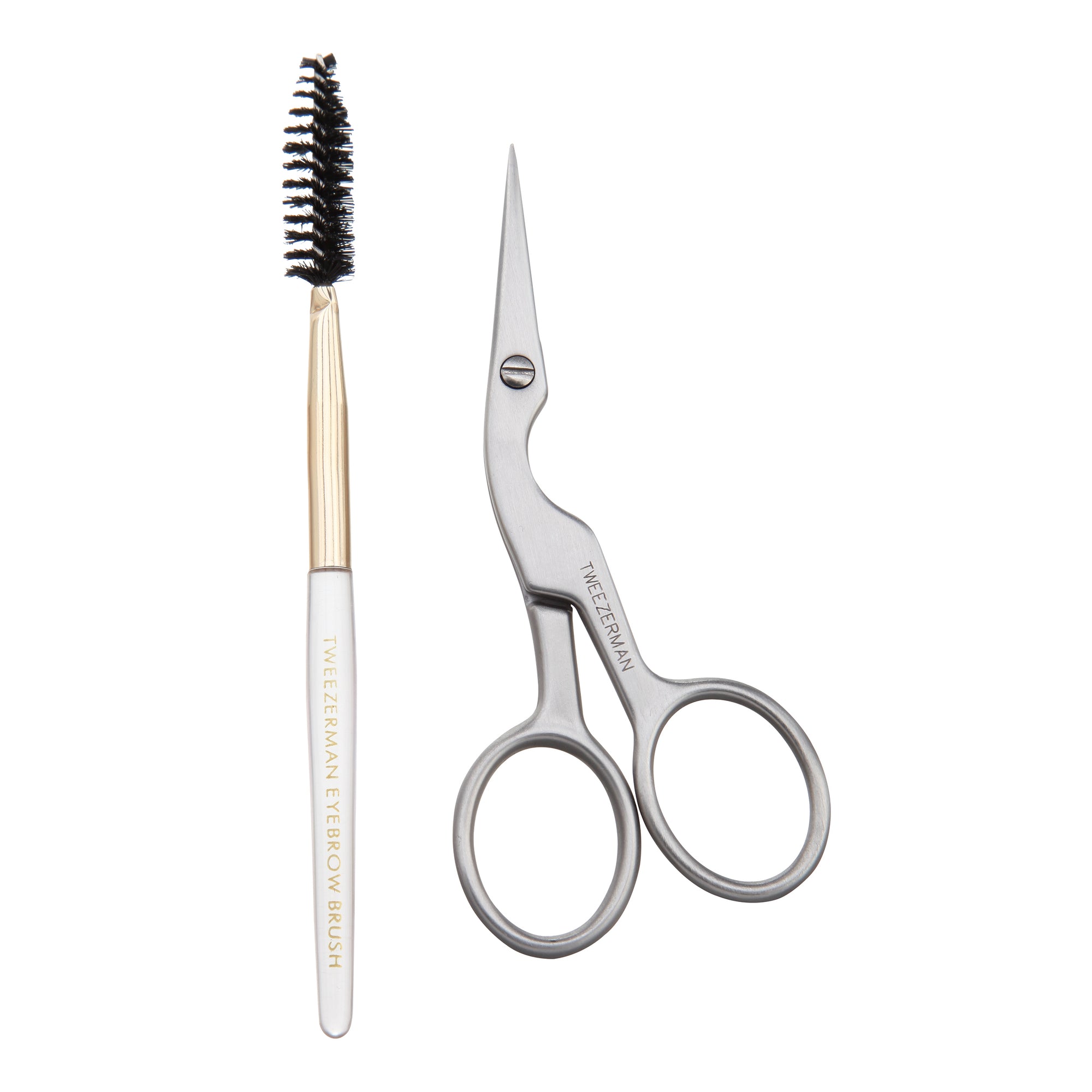 Brow shaping brush with white handle, gold ferrule, black spoolie brush head &quot;Tweezerman Eyebrow Brush&quot; in gold coloring written on brush handle. Stainless steel brow shaping scissors with contoured body and loop handles &quot;Tweezerman Italy&quot; written on scissors.
