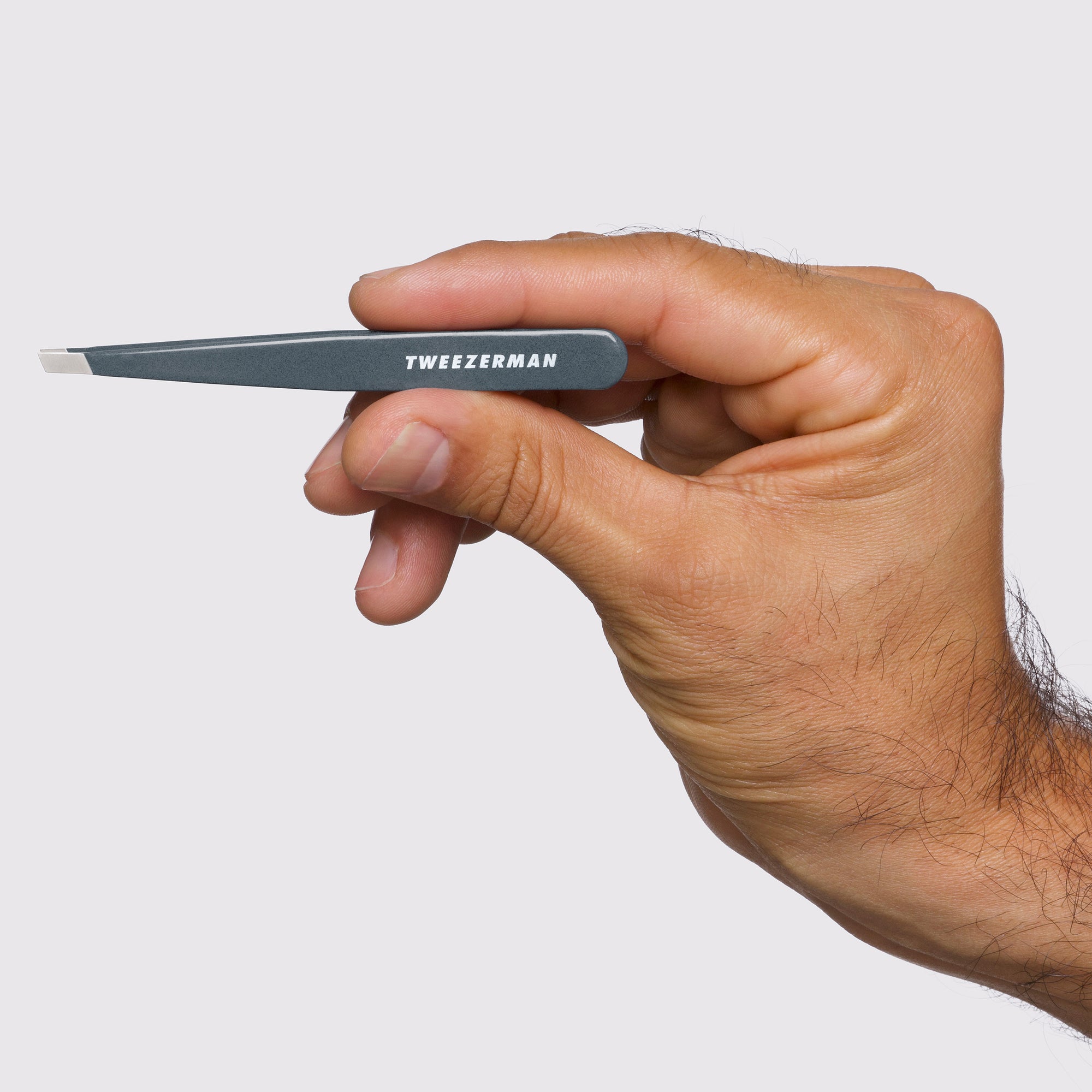 Female Model holding Blue Stone Slant Tweezer 