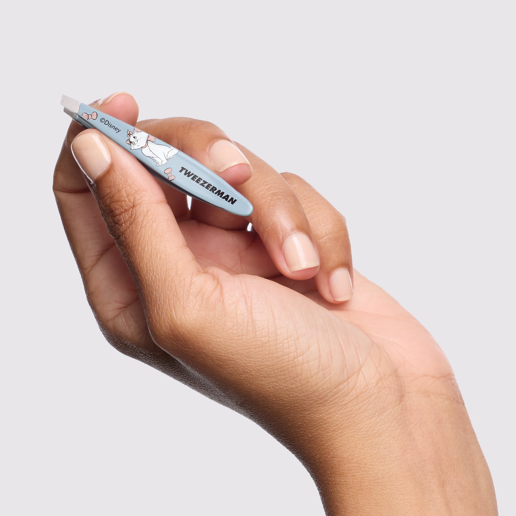 Model holding Disney&#39;s The Aristocats Mini Slant Tweezer