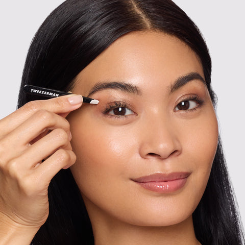 Model holding and using Dusted Onyx Mini Slant Tweezer