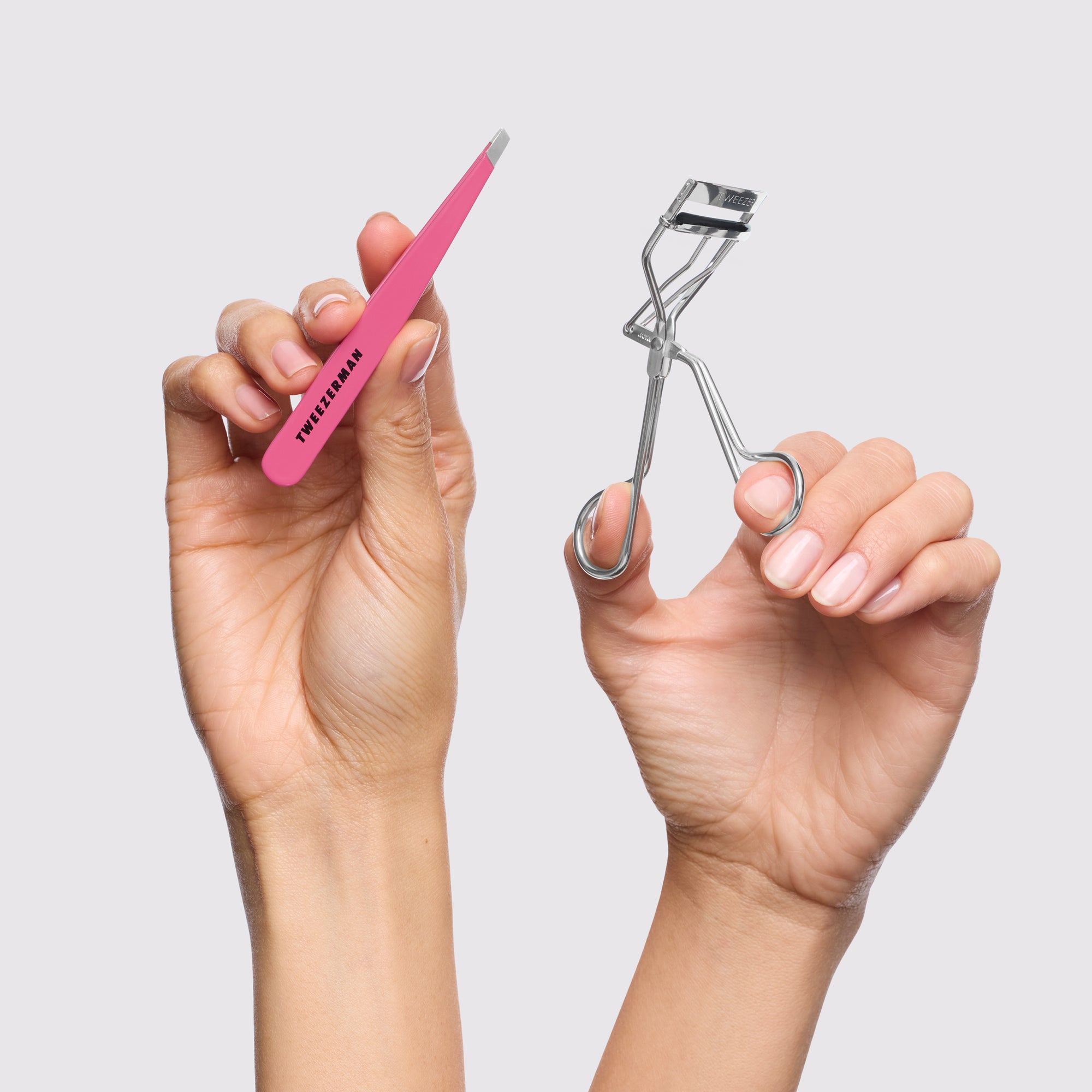 Model holding Eyelash Curler and Pink Slant Tweezer