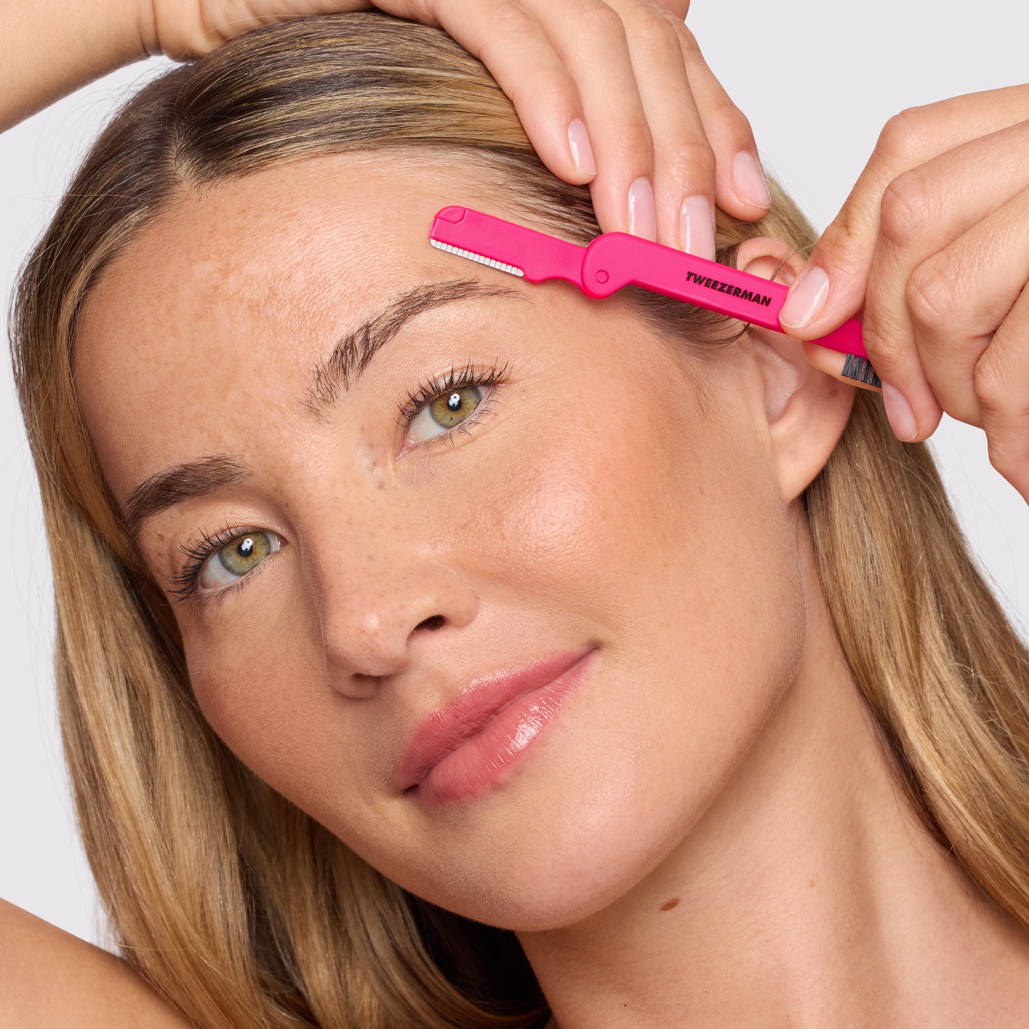 Model using razor side of Pink Dual-sided Precision Folding Razor