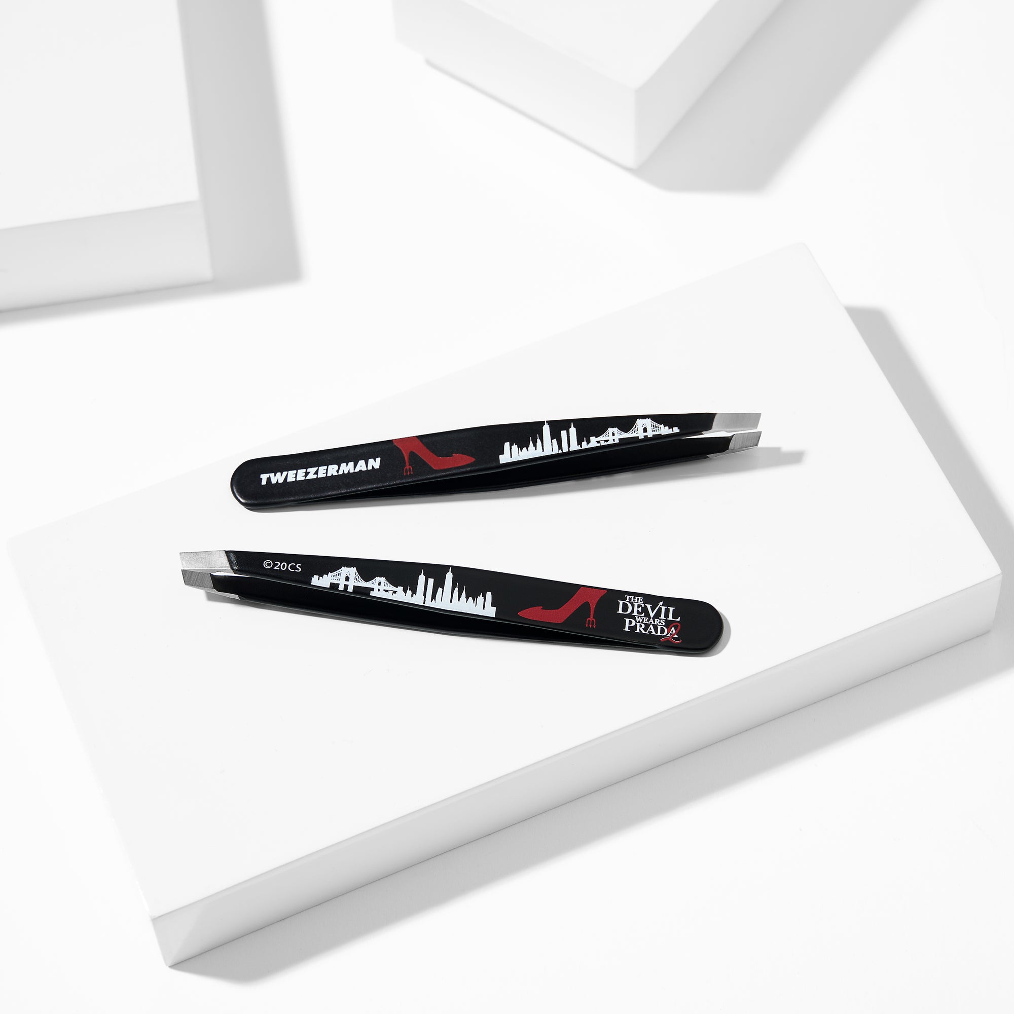 The Devil Wears Prada 2 Slant Tweezer placed on a white block tray