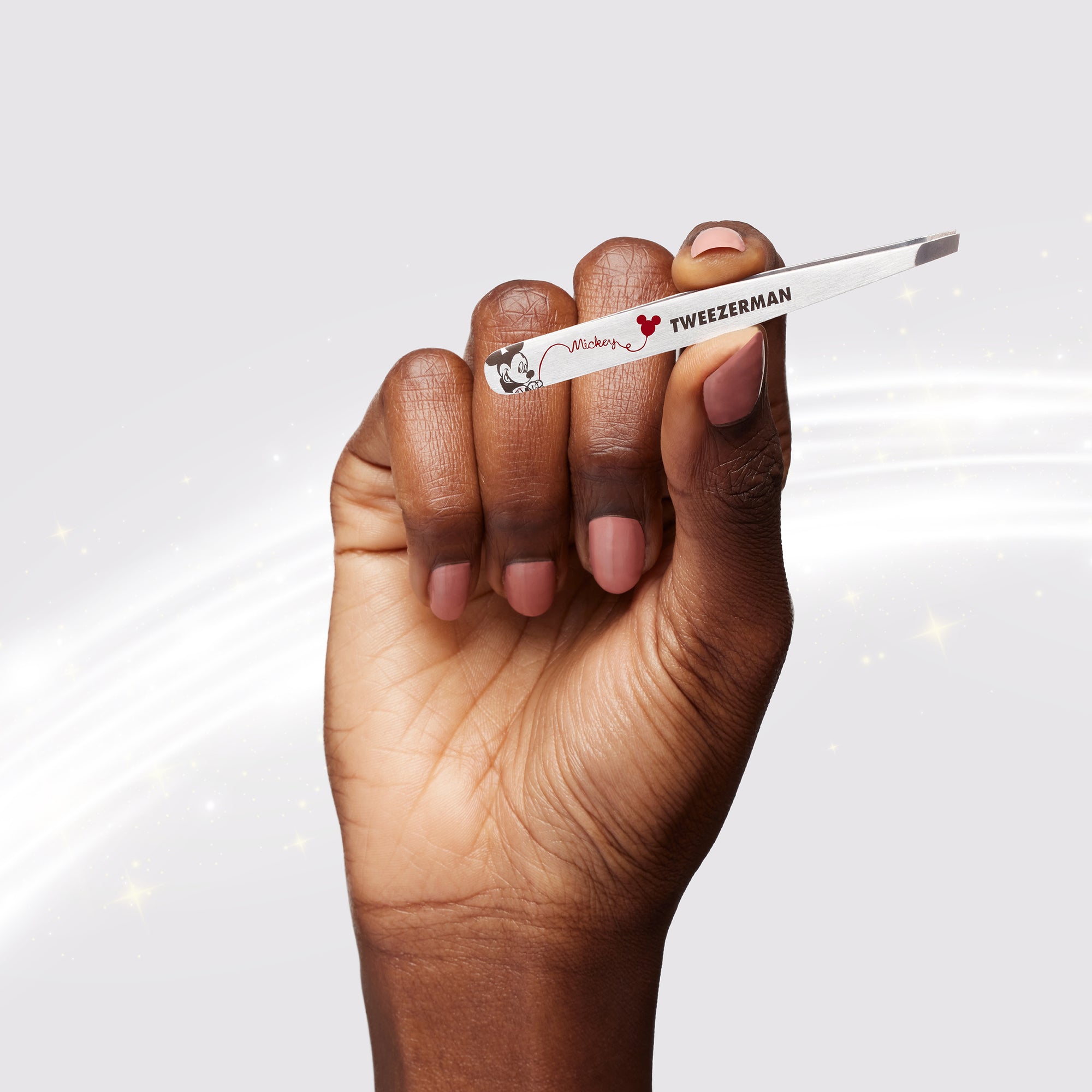 Model holding Stainless steel petite slant tweezer with red writing with Mickey and Minnie Mouse