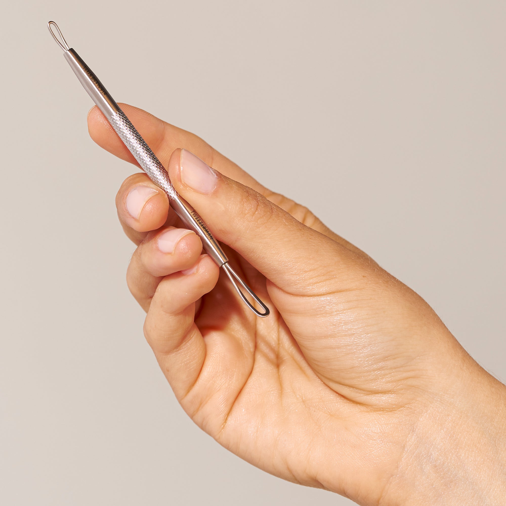 Female Model holding skincare tool in hand