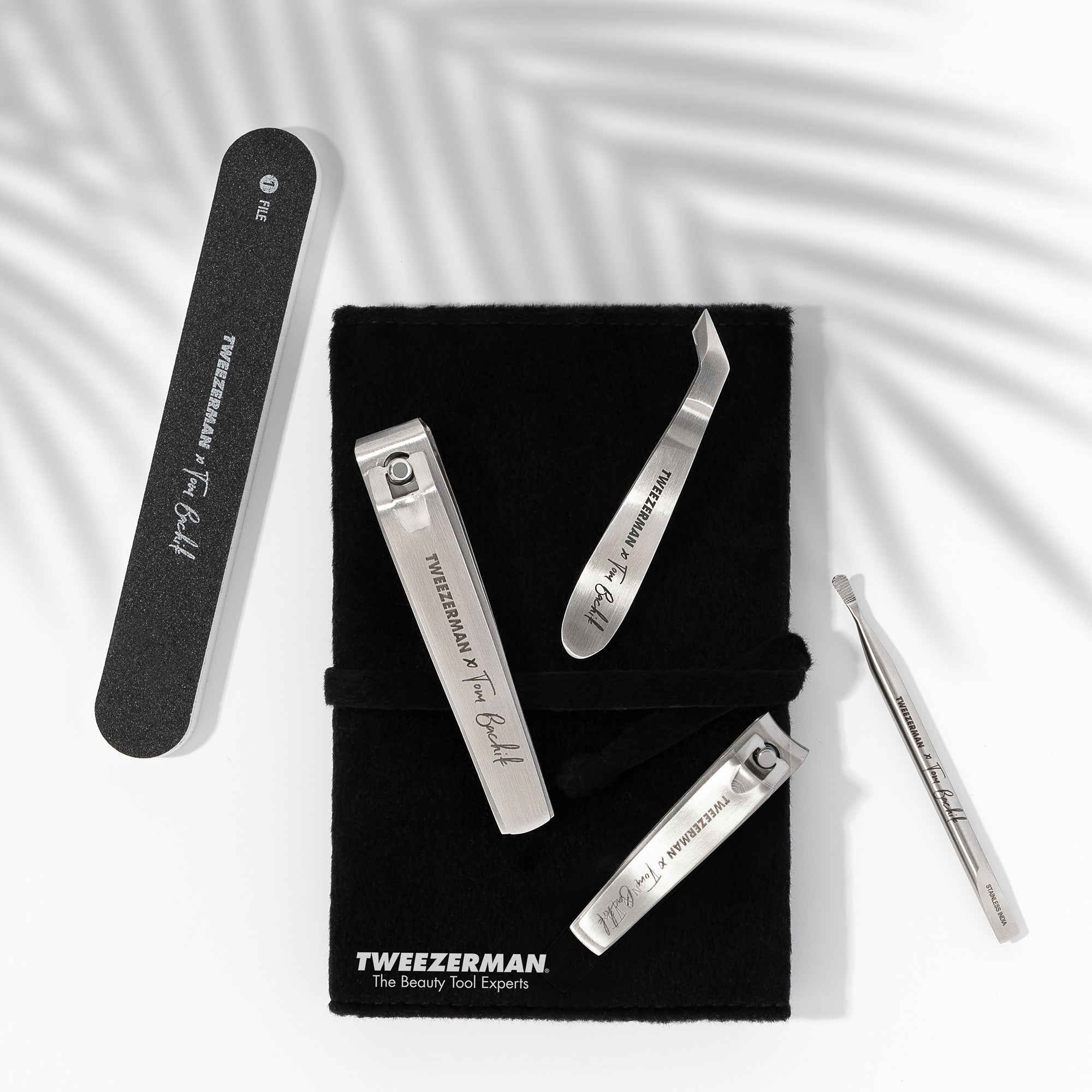 Black nail file, stainless steel fingernail and toenail clipper, stainless steel mini cuticle nipper and nail pushy cleaner with black felt carrying case. Case has white lettering on bottom &quot;Tweezerman The Beauty Tool Experts&quot;