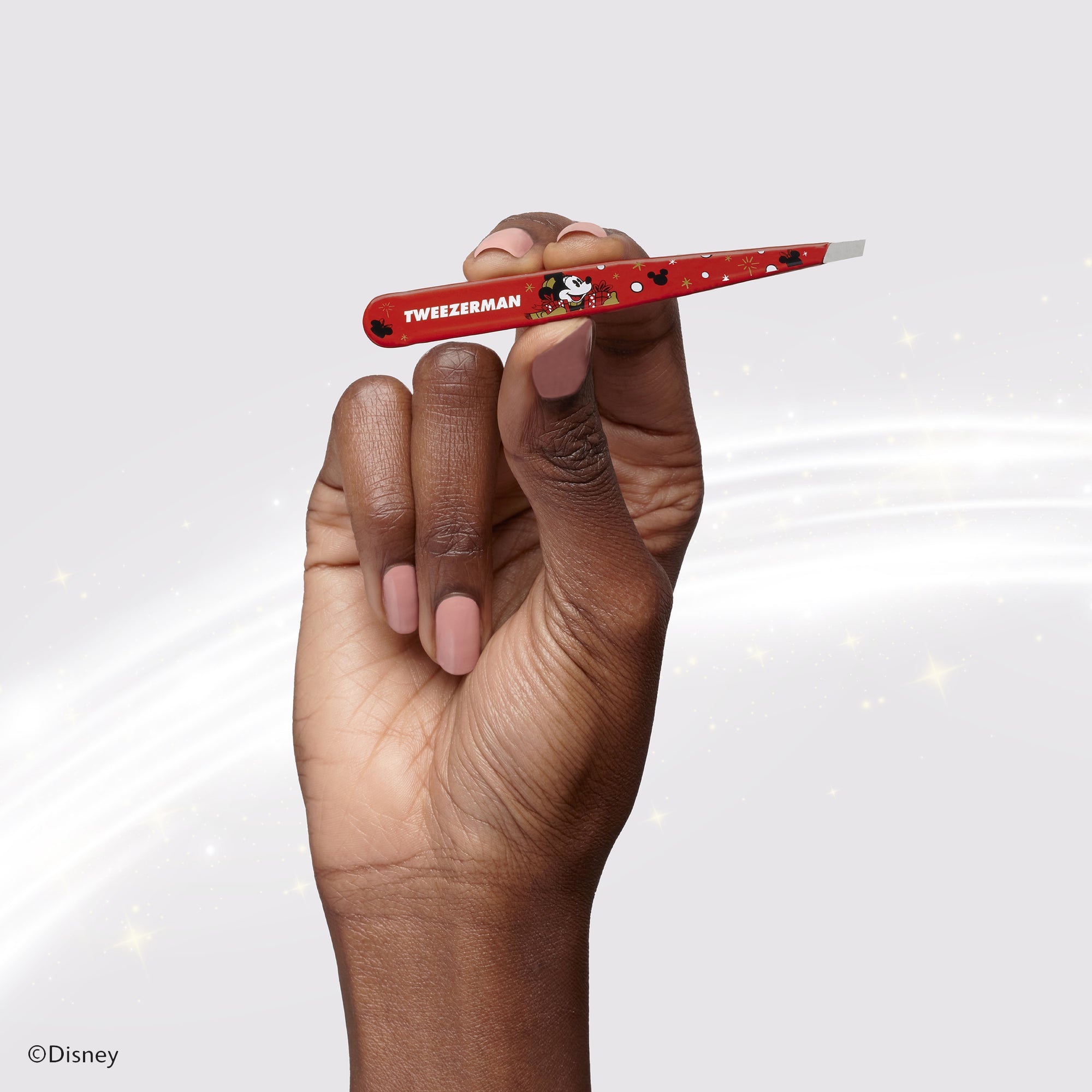 Model holding Disney&#39;s Mickey Mouse &amp; Minnie Mouse Magic all Around Slant Tweezer
