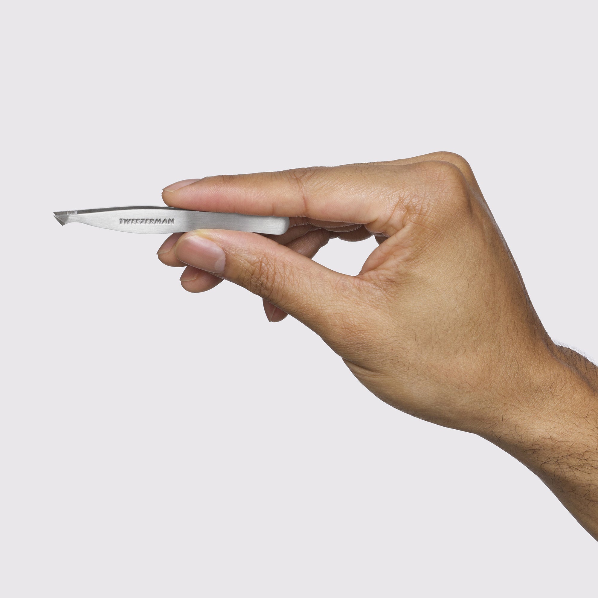 Male Model holding up Stainless Steel Pointed Slant Tweezer