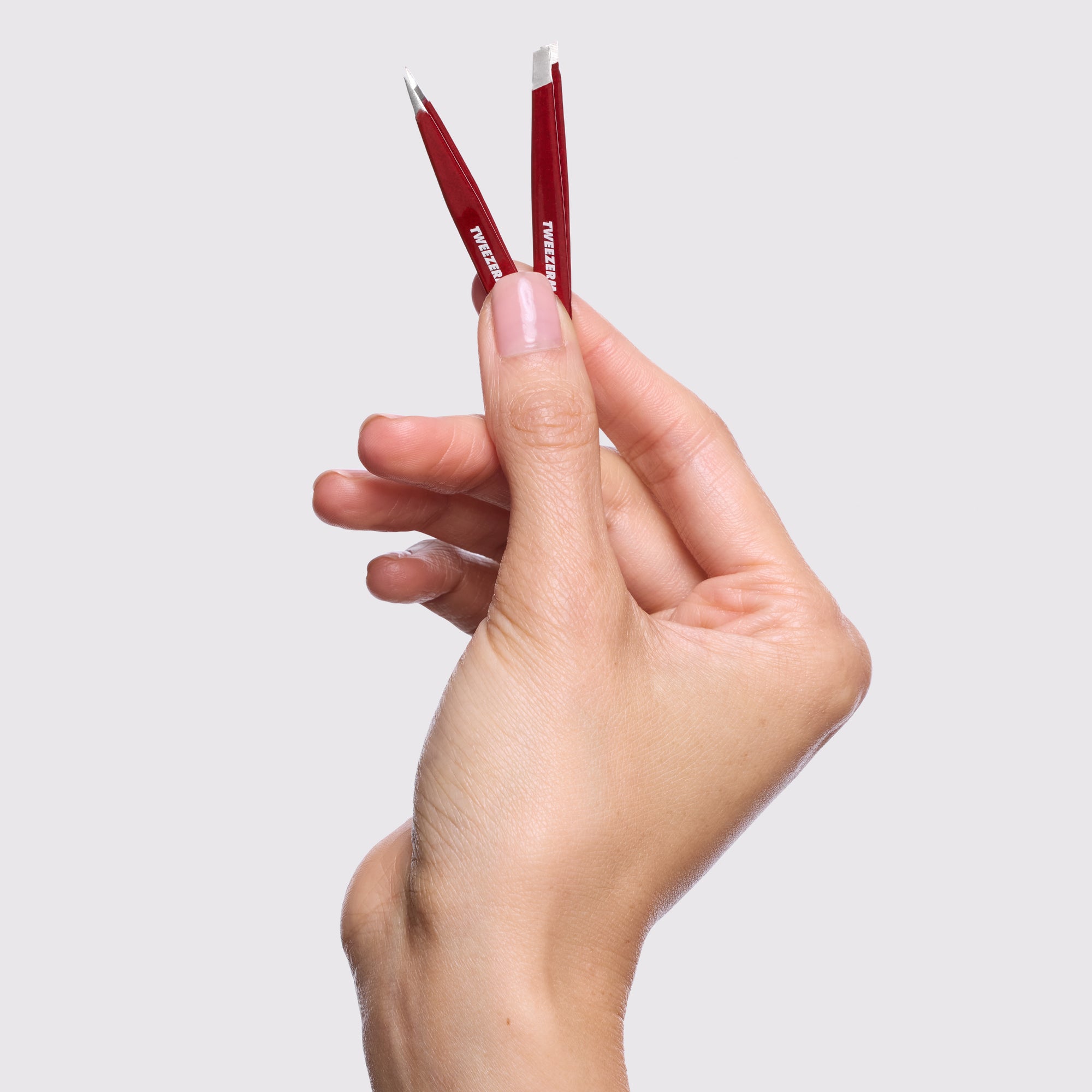 Model holding Vintage Rose Micro Mini Tweezer Set