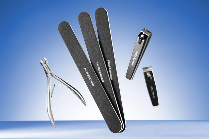 Set of nail care tools including cuticle nippers, files, and a clipper on a blue gradient background.
