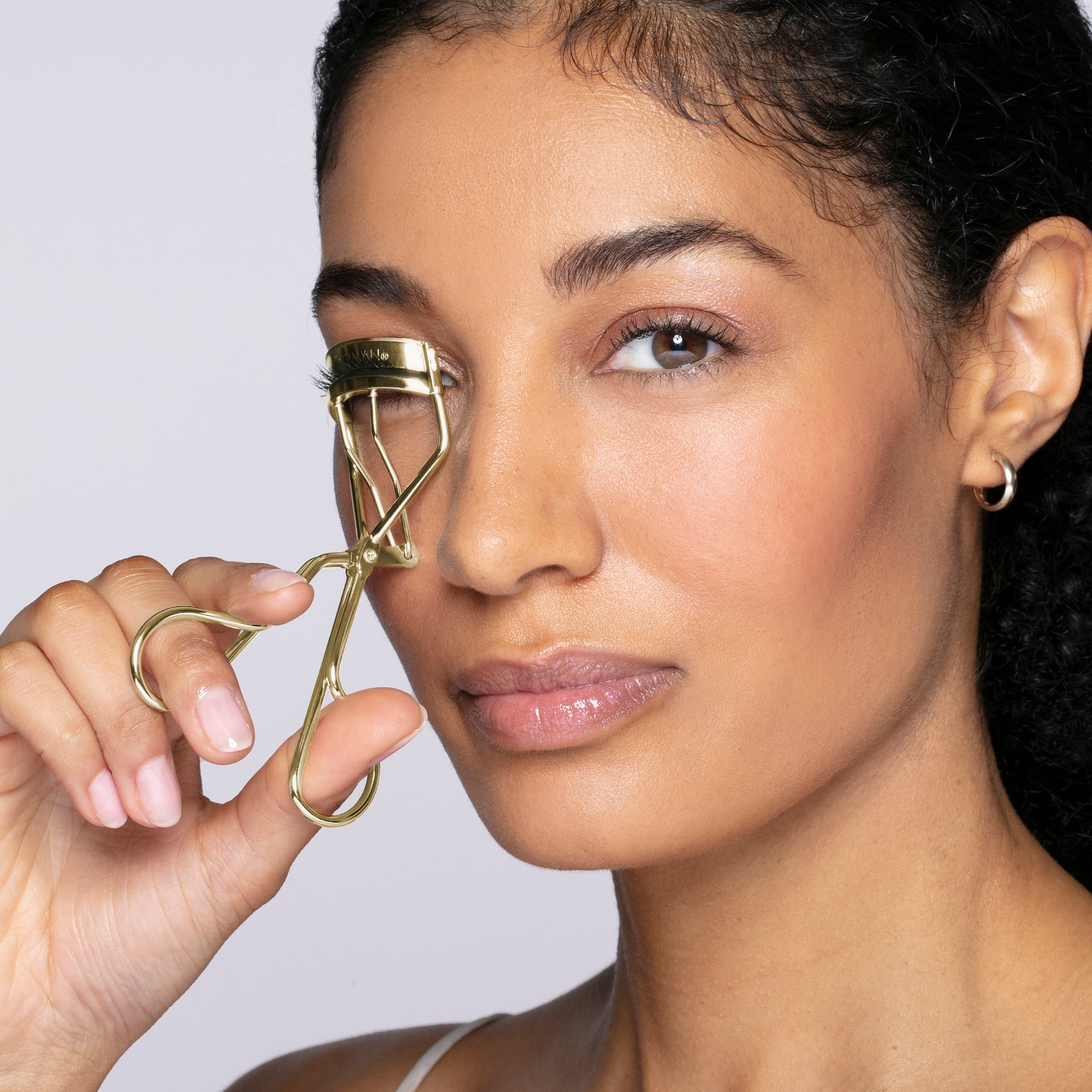 Model using Limited edition Gold classic eyelash curler