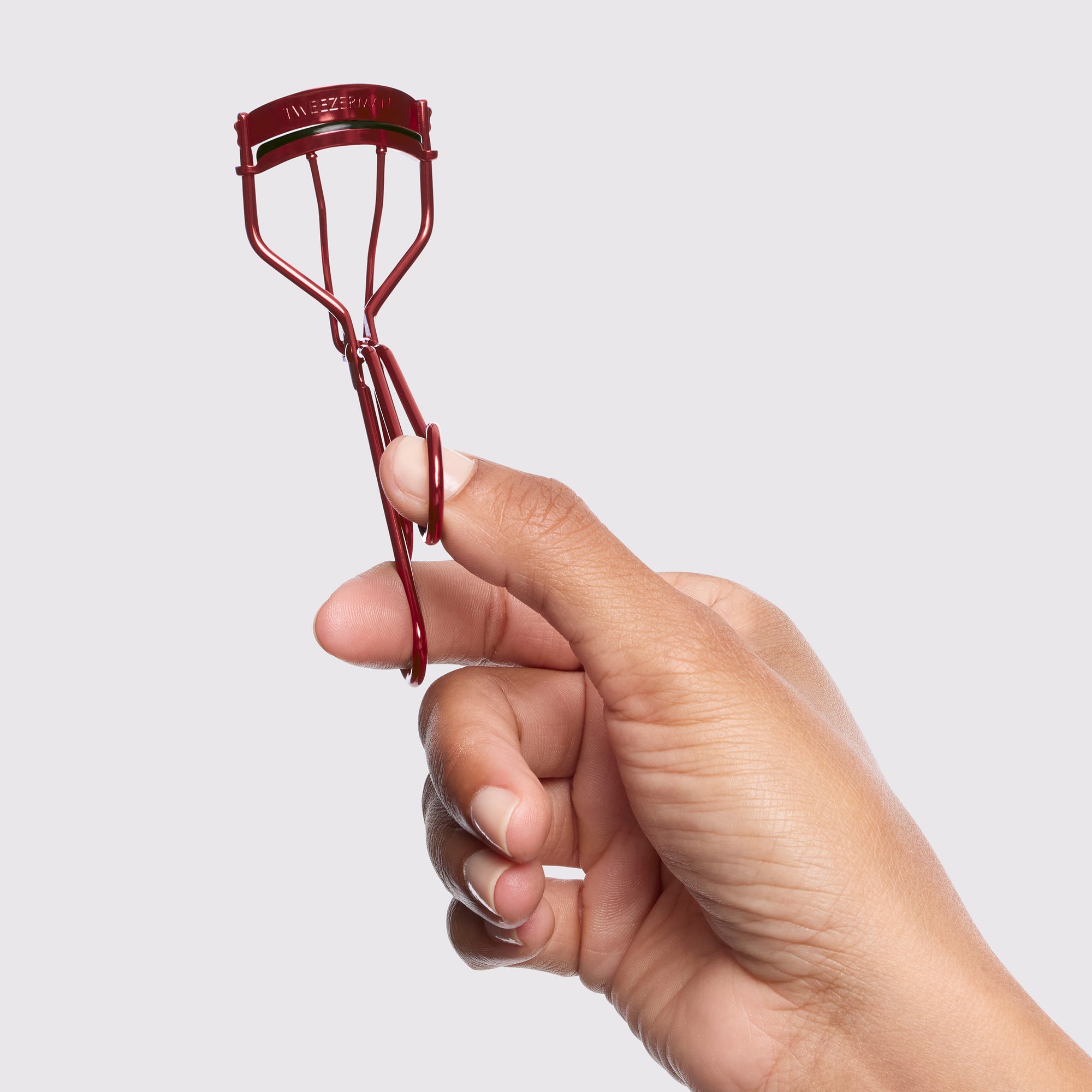 Model holding Vintage Rose Lash Curler