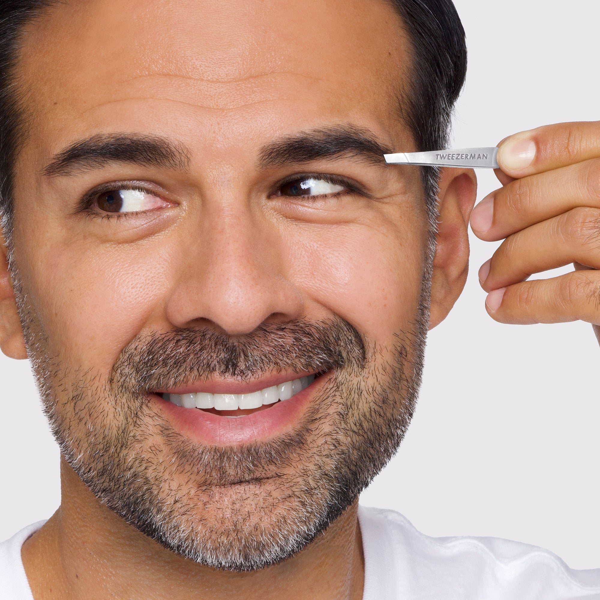 Male Model using Point Petite Tweezer on brows