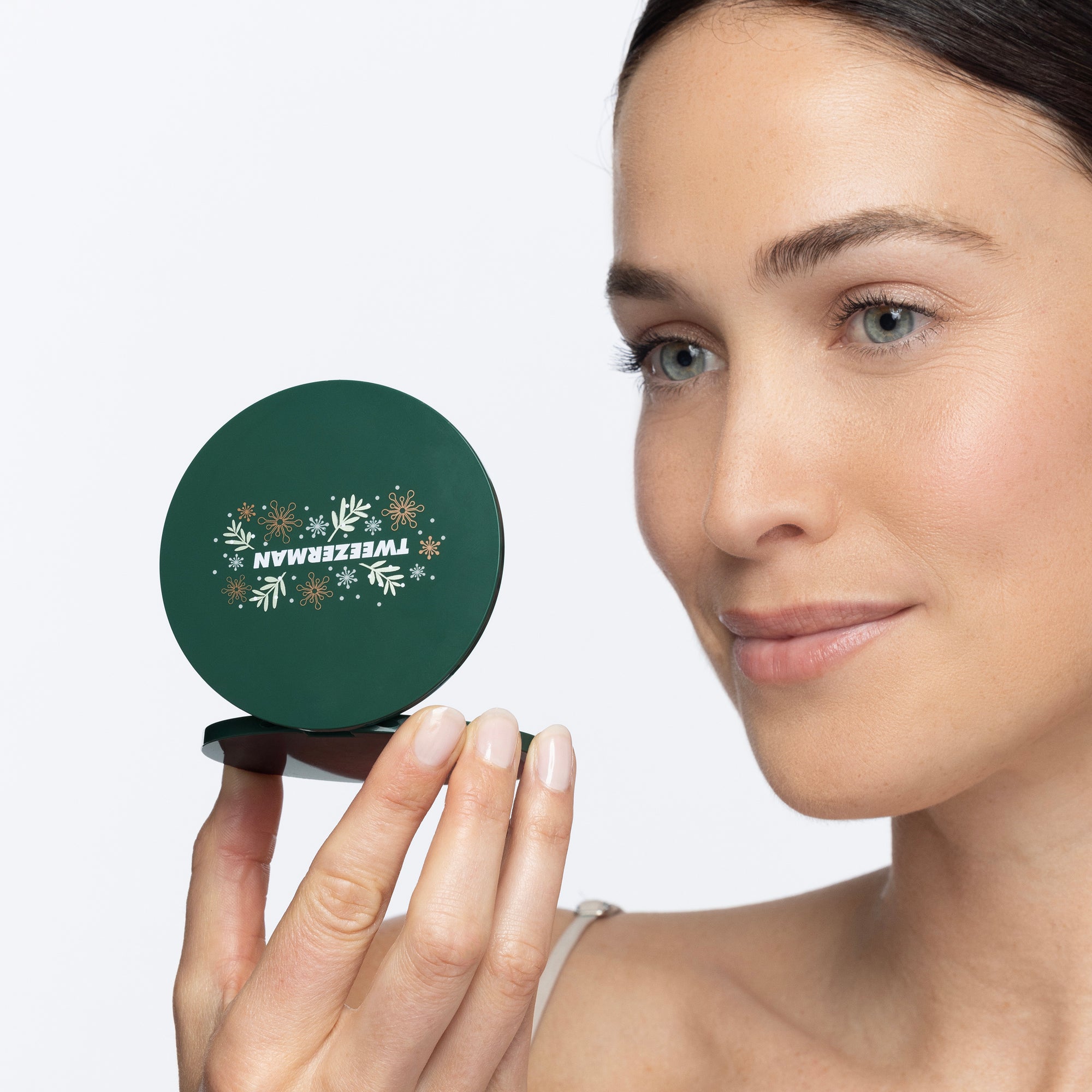 Model holding enchanted garden mini compact mirror