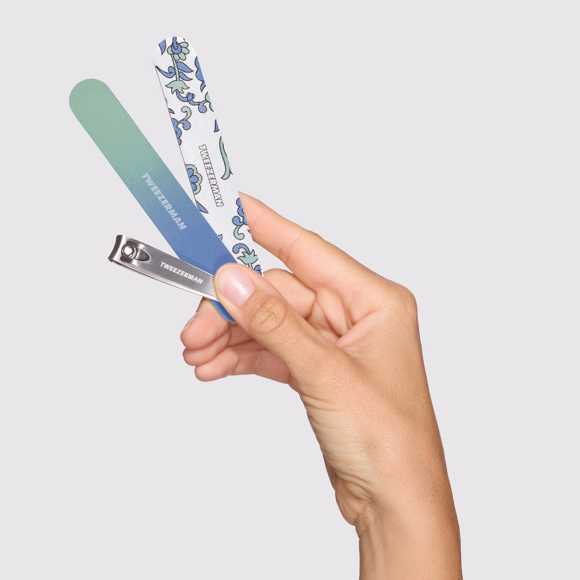 Model holding Blue and Green Paisley Manicure Kit