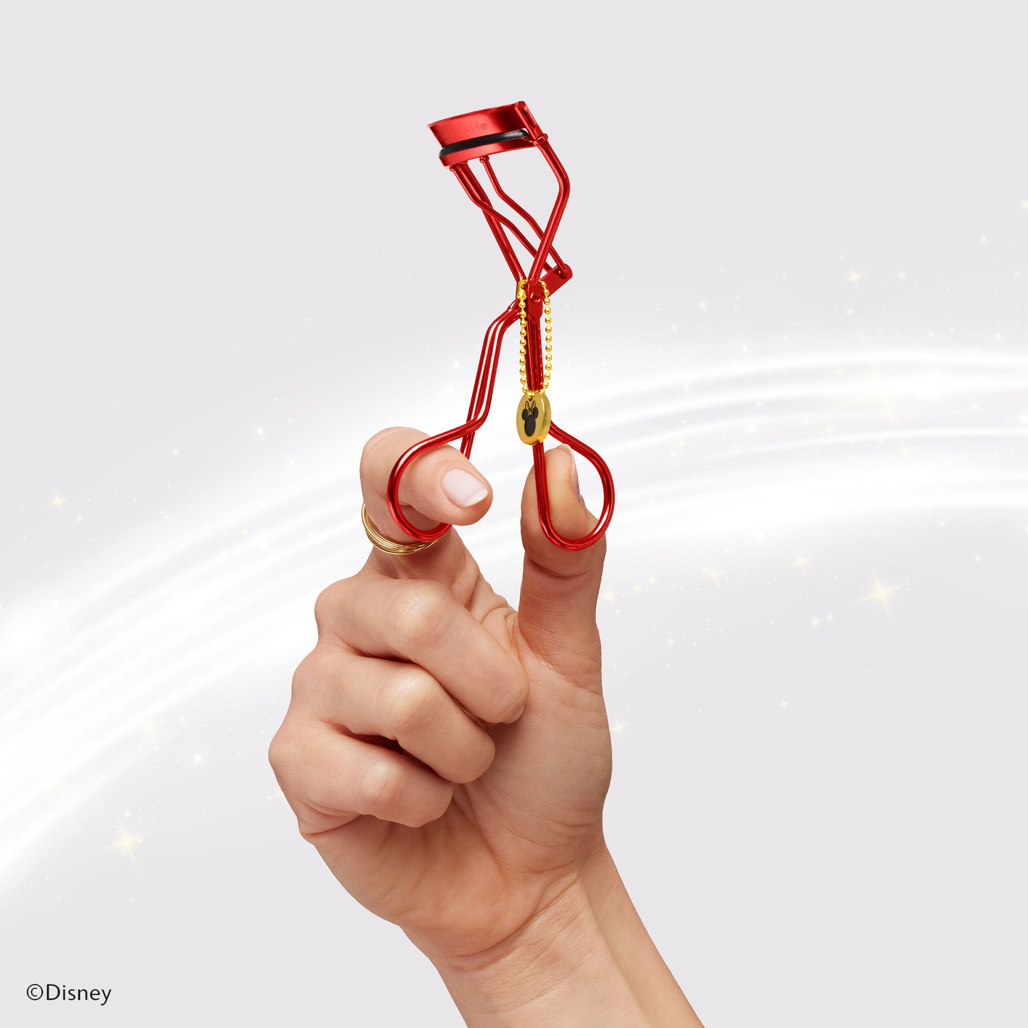 Model holding Disney&#39;s Mickey Mouse &amp; Minnie Mouse Magic All Around Lash Curler from set