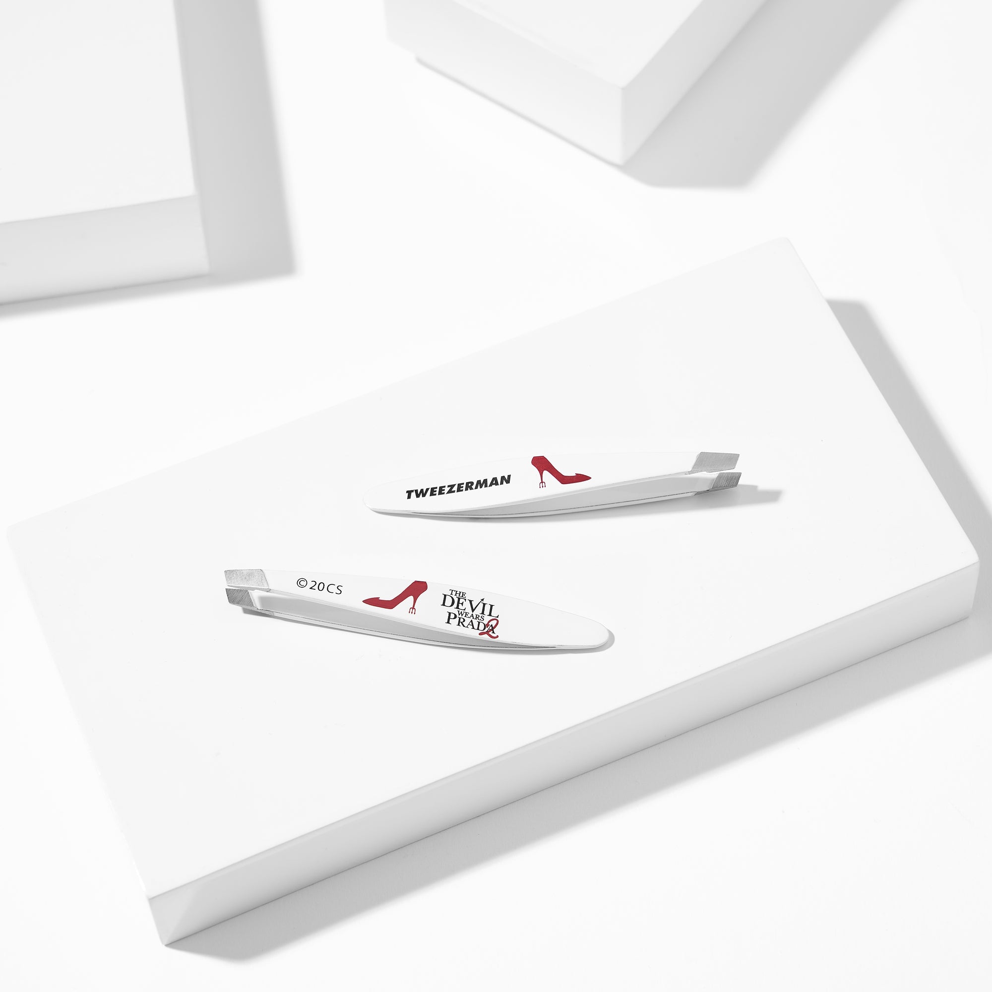 The Devil Wears Prada 2 Mini Slant Tweezer is placed on a white block tray