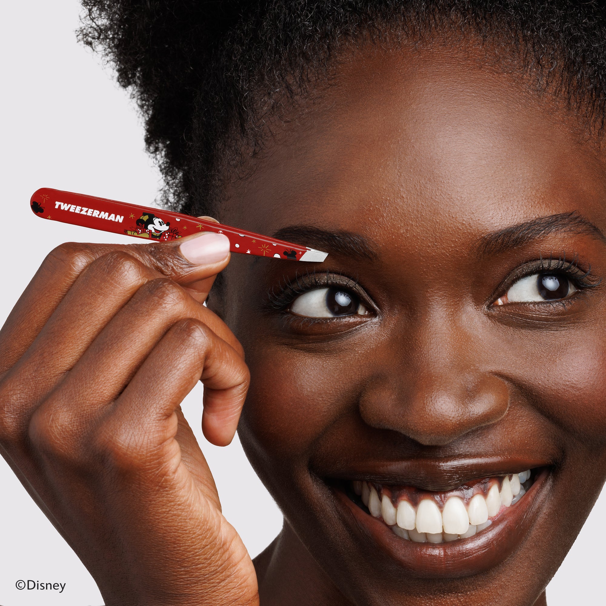 Model using Disney&#39;s Mickey Mouse &amp; Minnie Mouse Magic all Around Slant Tweezer