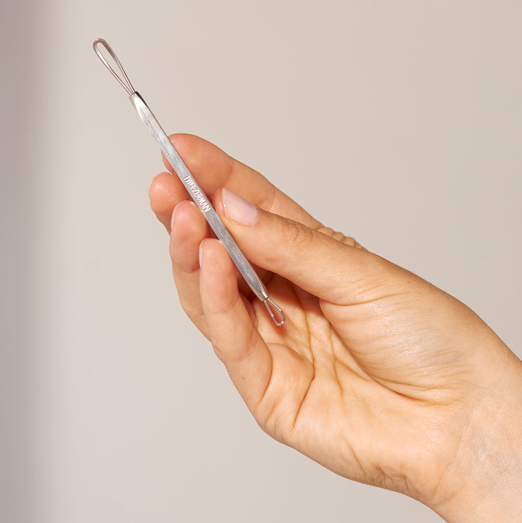 Model holding up Whitehead and Blackhead Remover