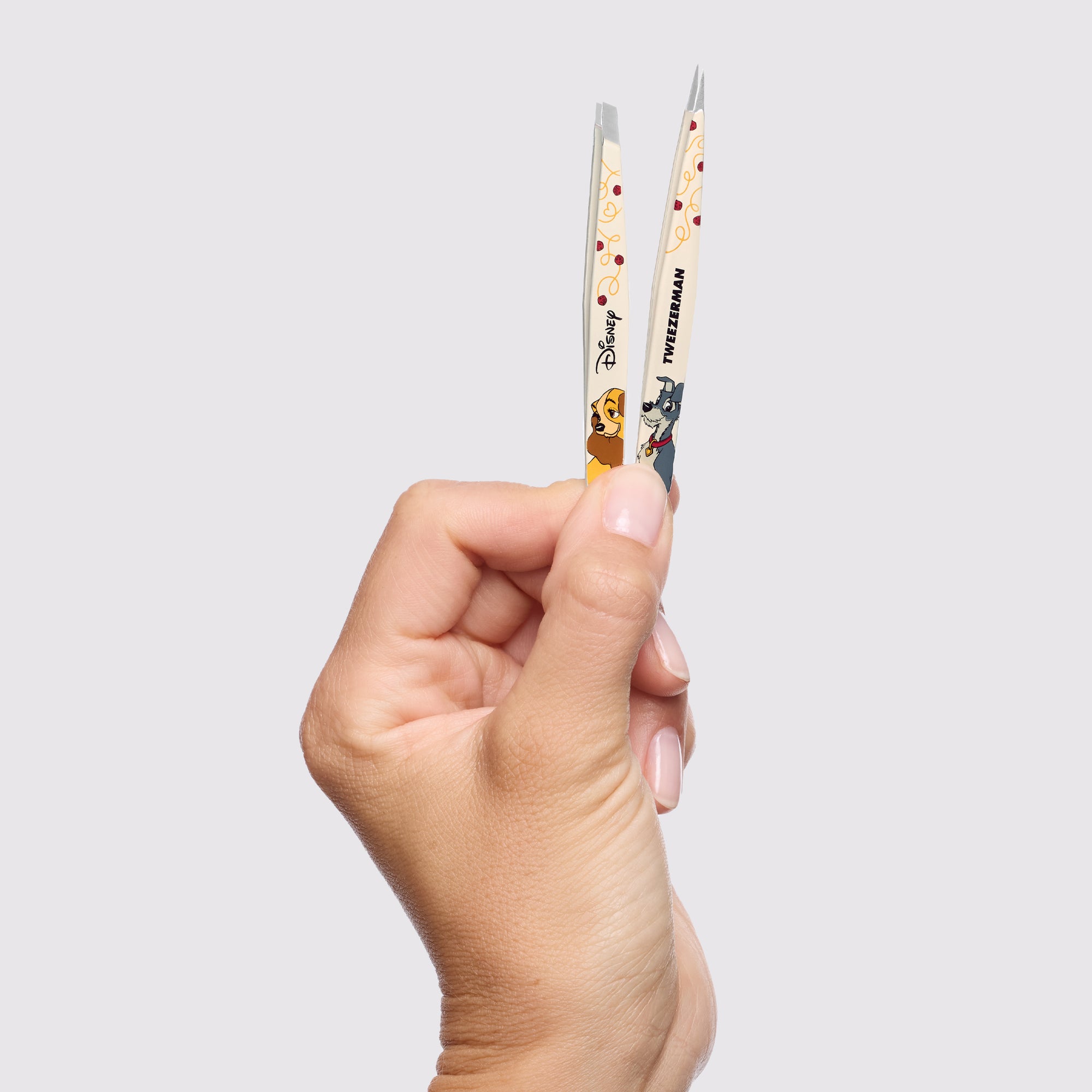 Model holding Disney&#39;s Lady and the Tramp Petite Tweezer Set