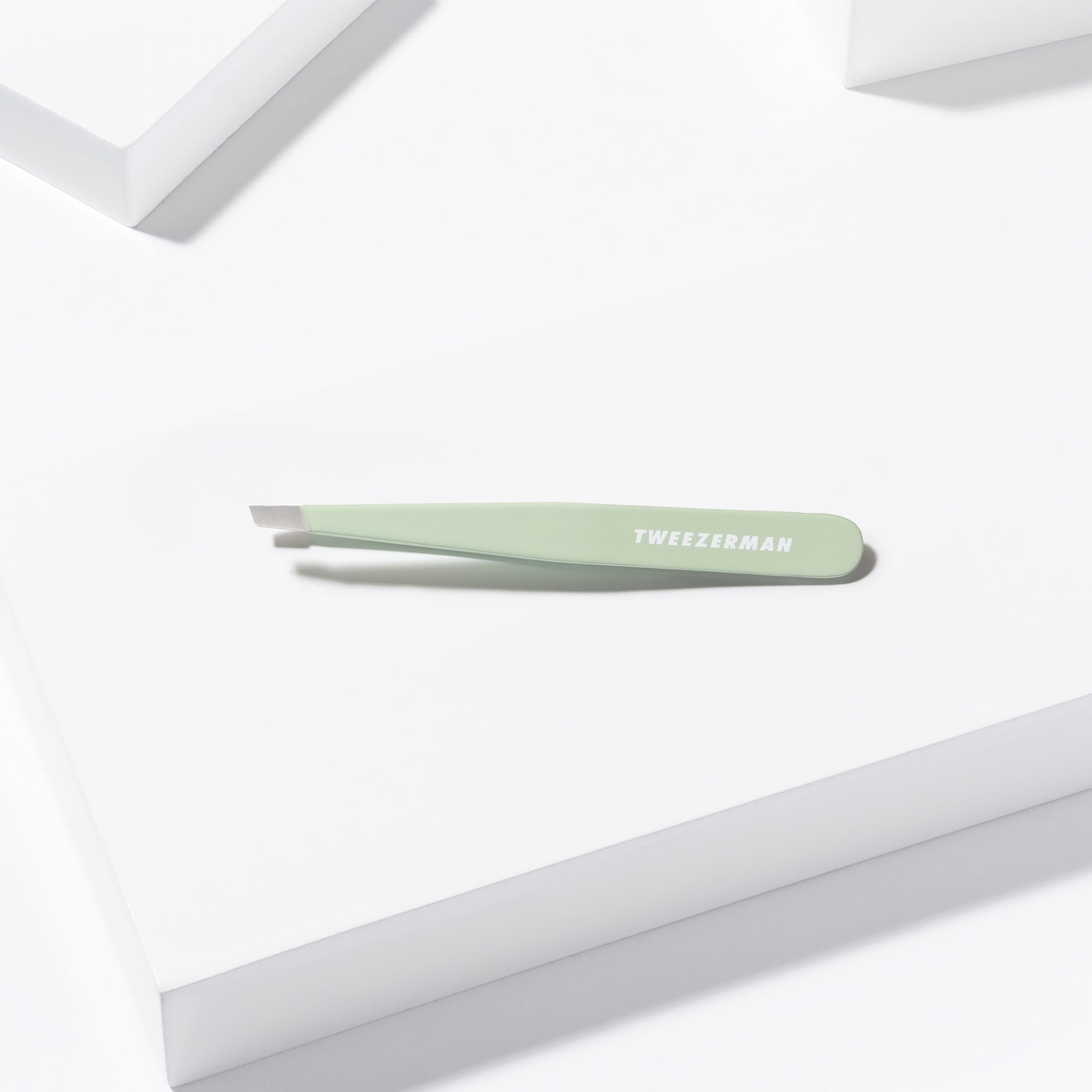 Pistachio Full Slant Tweezer placed on a white background