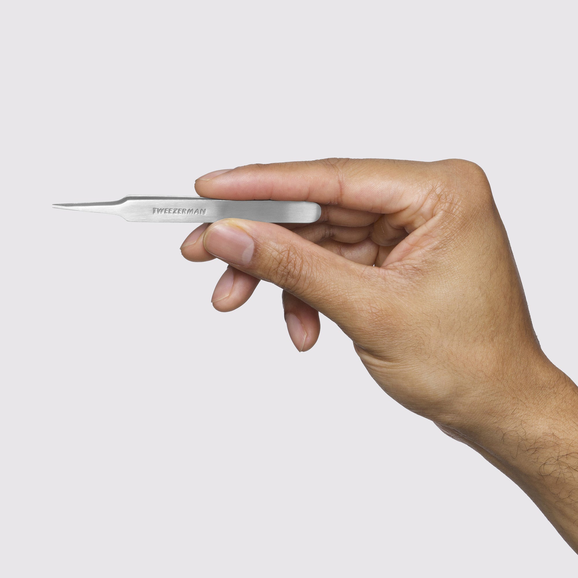 Male Model holding up Stainless Steel Ingrown Hair Splintertweezer