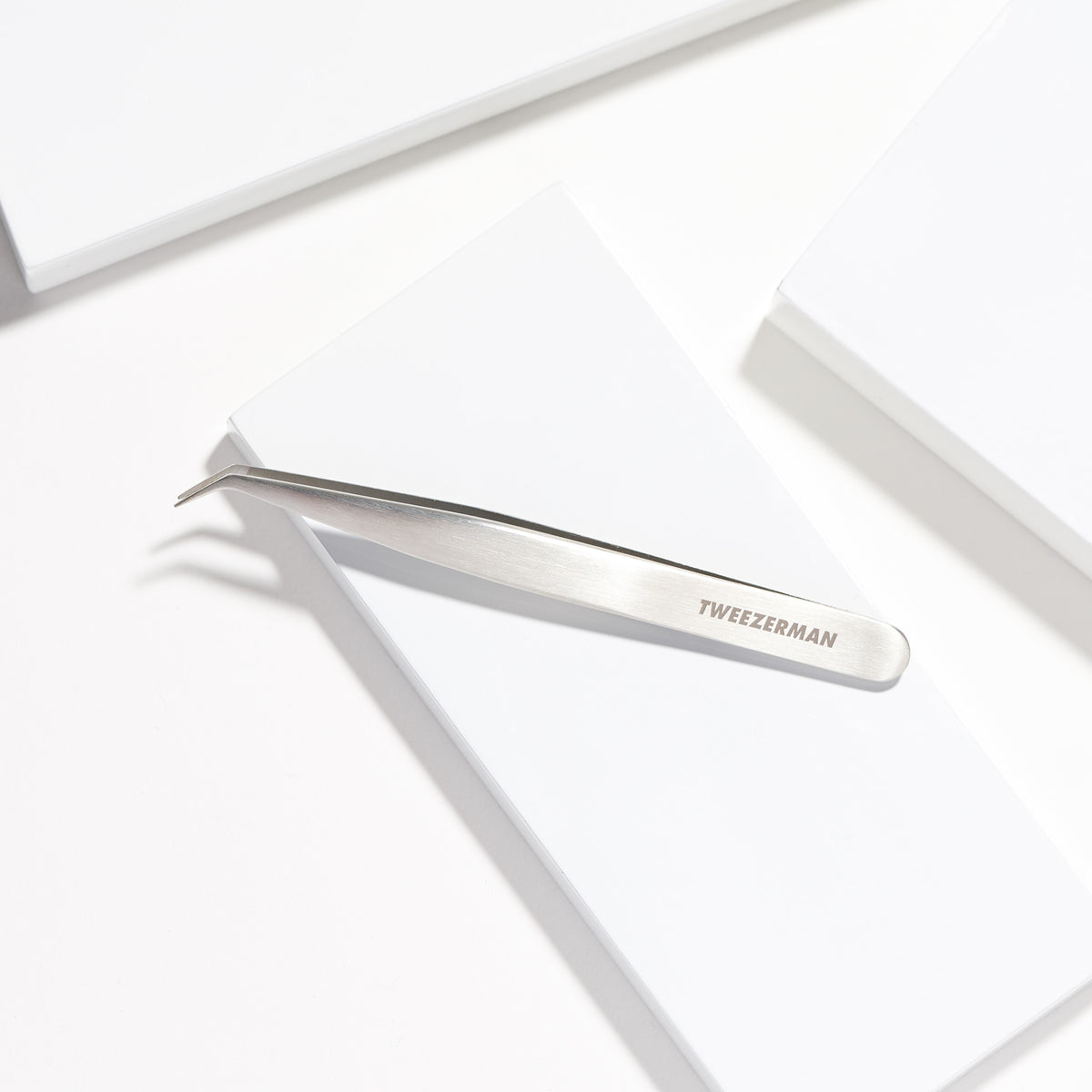 Stainless Steel Lash Assist placed on a white block tray