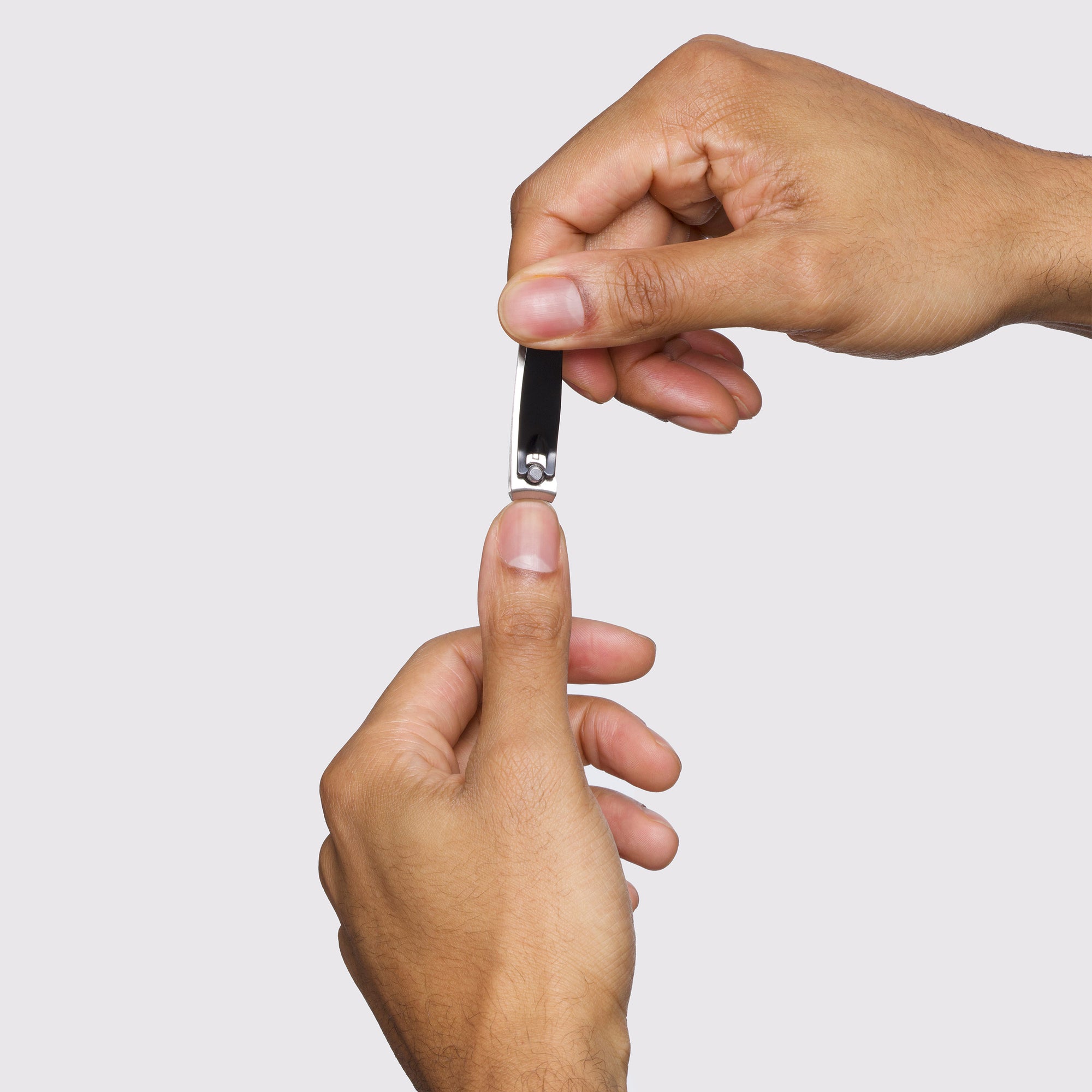 Male model using Combo Clipper Set; fingernail clipper