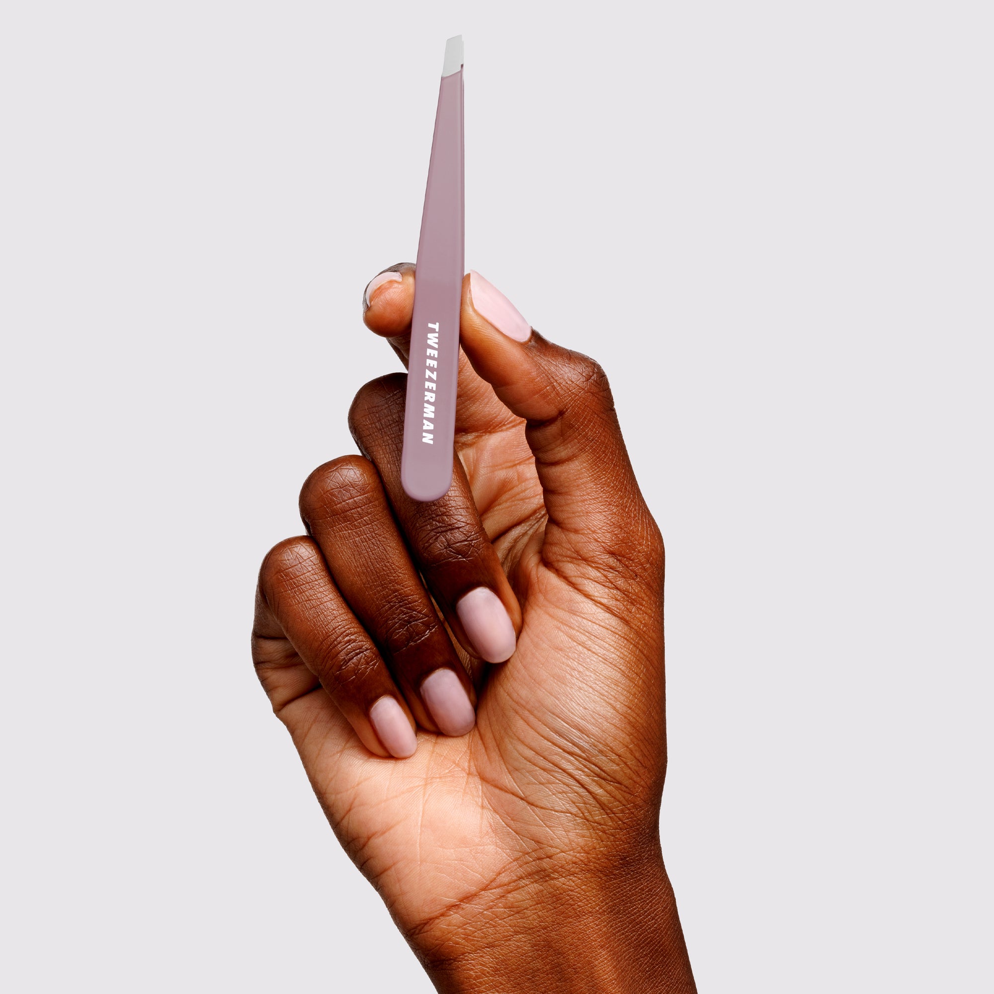 Model holding the Purple Wisteria Slant Tweezer