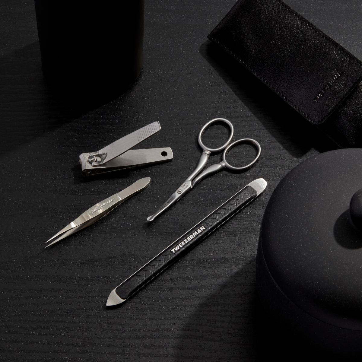 Essential Grooming Kit placed on a dark toned color table