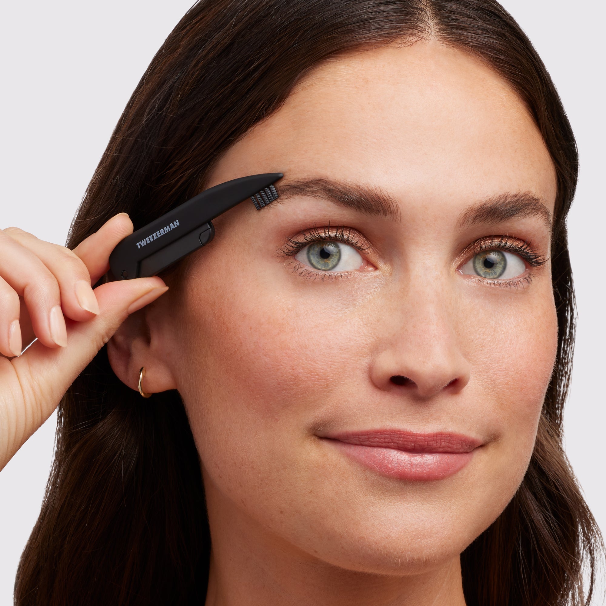 Model using razor end of Dual ended Black Precision folding razor and brush