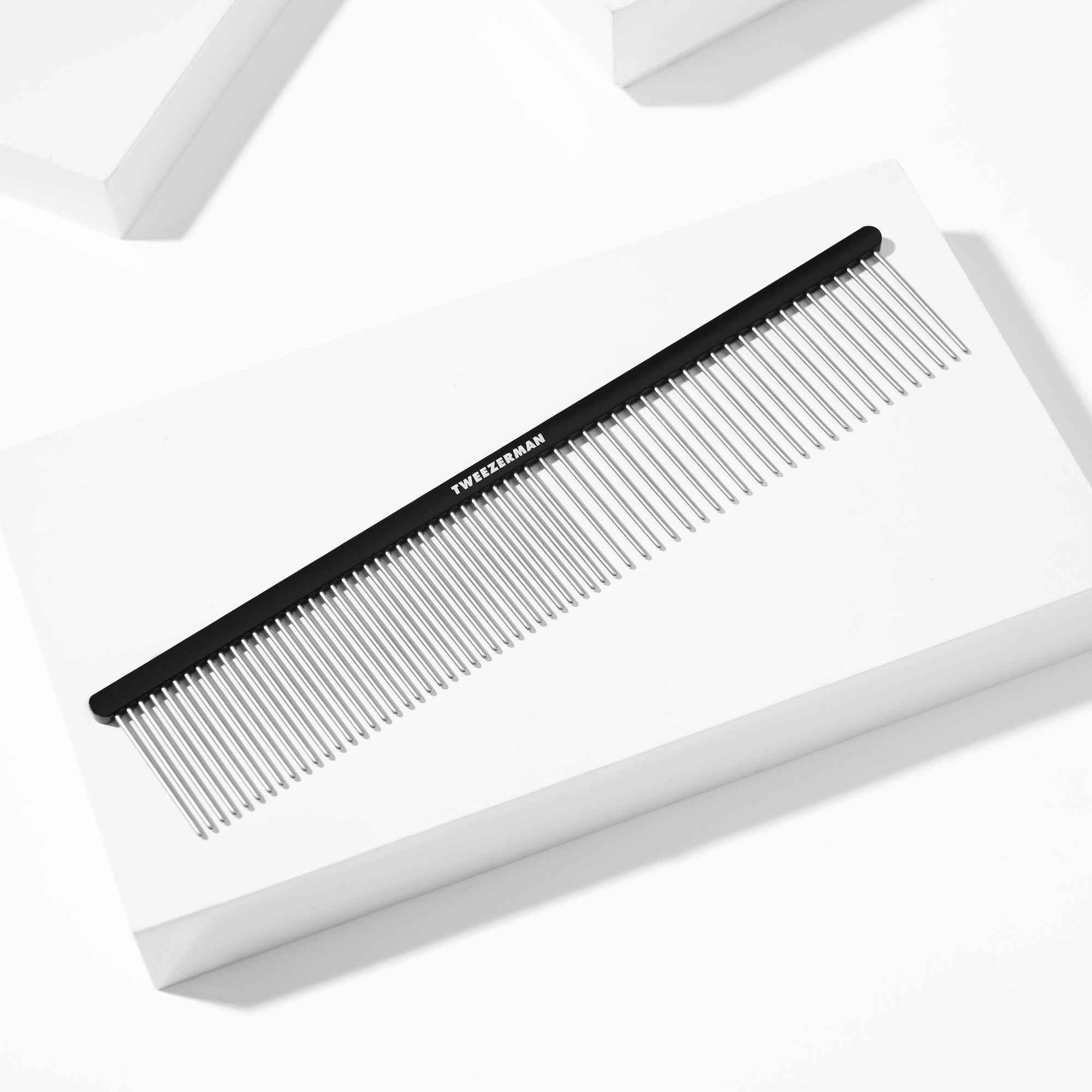 Dual-Sided Detangling Comb displayed on a white block tray background