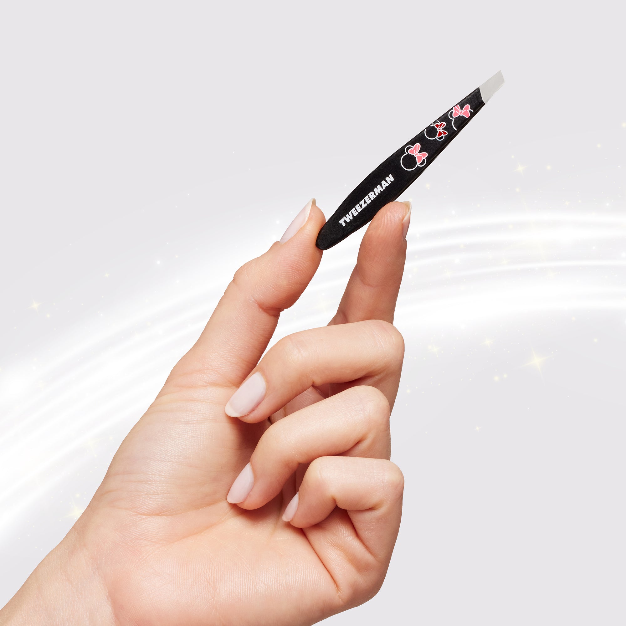 Model  holding Ear-esistible Mini Slant Tweezer